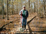 Mike Kowalski, who has been observing and studying water beetles at Whitehall Nature Preserve for many years, holds a collecting net on the boardwalk