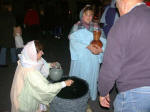 Women draw water at the well.