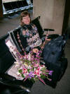 Ruth with 7th wedding anniversary flowers, Kansas City airport 