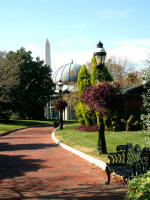 Nineteenth-century-style lamps and antique cast-iron settees line the Enid A. Haupt rooftop garden walkways 