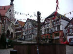 Lion statue crowns the 15th century fountain surrounded by old half-timbered houses around the exquisite market square, nestled among the granite and sandstone mountains of south-west Germany.