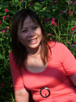 Vi stops to enjoy the flowers along the colonnade.